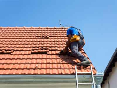 roofing contractor inspecting roof surface in Folsom